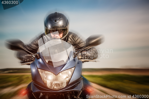 Image of Biker racing on the road