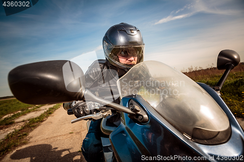 Image of Biker racing on the road