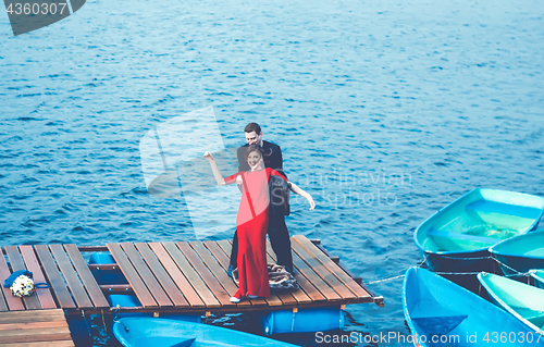 Image of Happy Couple Having Fun On The Pier