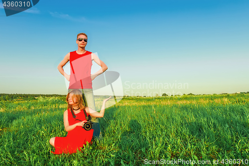 Image of Young Couple Having Fun In The Green Field