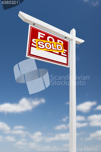 Image of Left Facing Sold For Sale Real Estate Sign on a Blue Sky with Cl