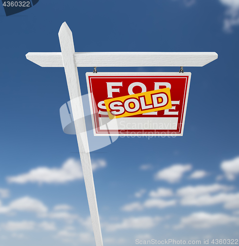 Image of Right Facing Sold For Sale Real Estate Sign on a Blue Sky with C