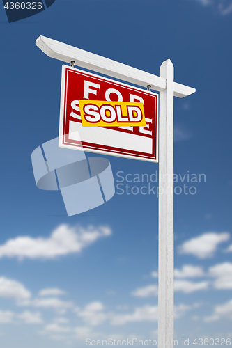 Image of Left Facing Sold For Sale Real Estate Sign on a Blue Sky with Cl