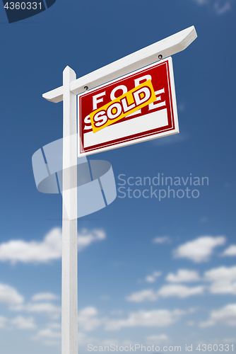 Image of Right Facing Sold For Sale Real Estate Sign on a Blue Sky with C