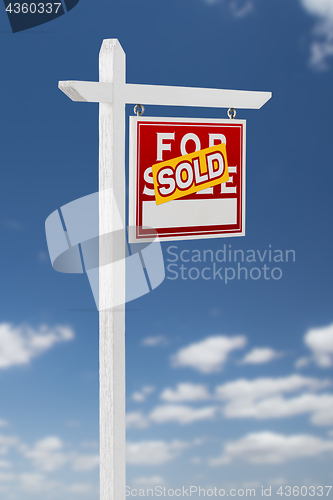 Image of Right Facing Sold For Sale Real Estate Sign on a Blue Sky with C