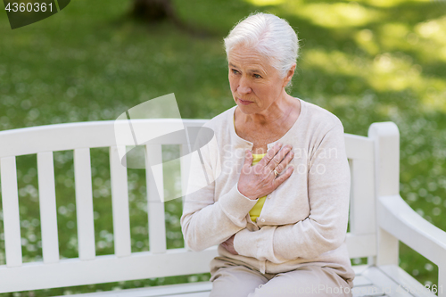Image of senior woman feeling sick at summer park