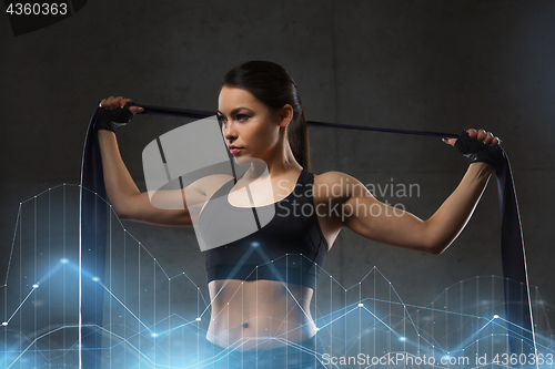 Image of woman with expander exercising in gym