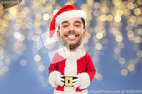 Image of man in santa claus costume over christmas lights