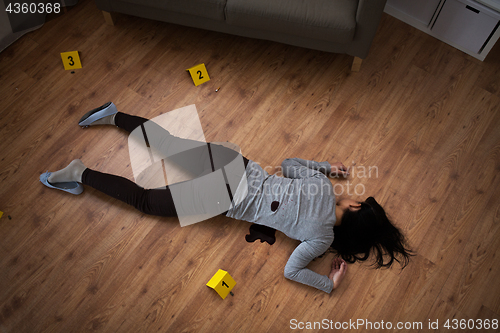Image of dead woman body in blood on floor at crime scene