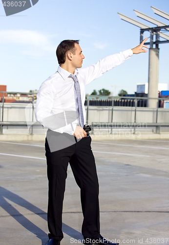 Image of businessman in a front of a building site