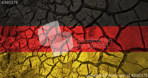 Image of german flag on cracked ground background