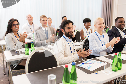 Image of people applauding at business conference