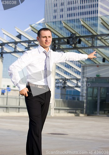 Image of businessman in a front of a building site