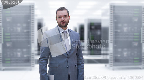 Image of Young businessman in server room