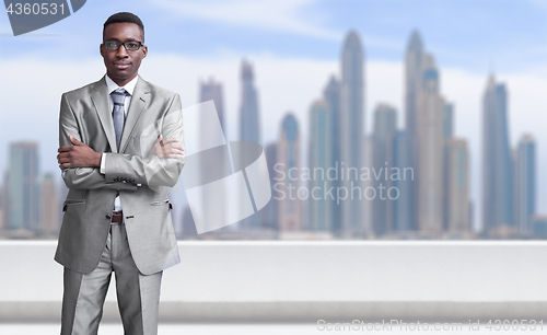 Image of Young black businessman in front of the big city