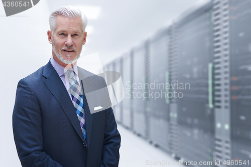 Image of Senior businessman in server room