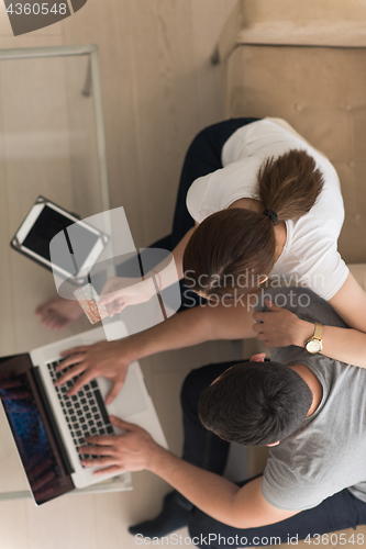 Image of happy young couple buying online