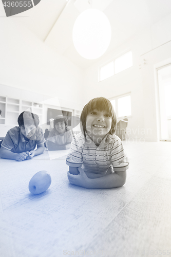 Image of boys having fun with an apple on the floor