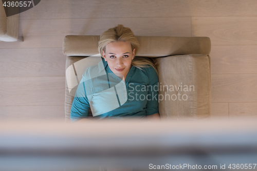 Image of woman on sofa using tablet computer