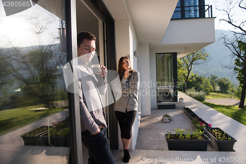 Image of couple enjoying on the door of their luxury home villa