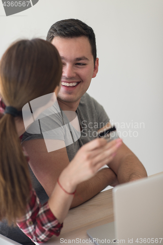 Image of happy young couple buying online