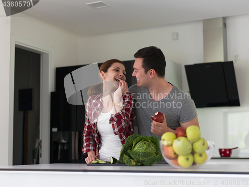 Image of Young handsome couple in the kitchen