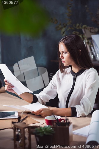 Image of Portrait of a businesswoman who is working at office