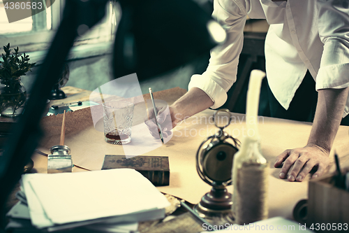 Image of Architect working on drawing table in office