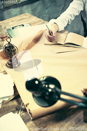 Image of Architect working on drawing table in office