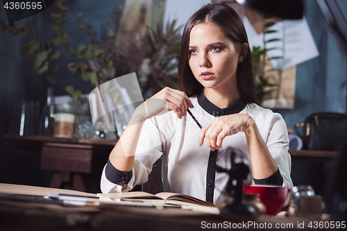 Image of Portrait of a businesswoman who is working at office