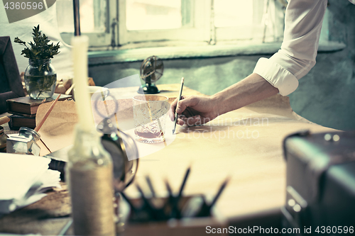 Image of Architect working on drawing table in office