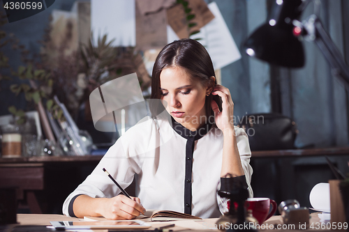 Image of Portrait of a businesswoman who is working at office
