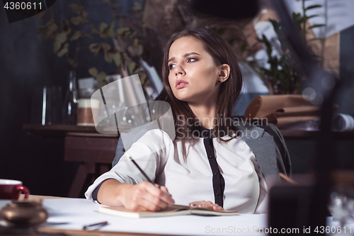 Image of Architect working on drawing table in office