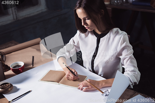 Image of Architect working on drawing table in office