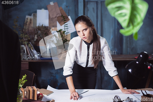 Image of Architect working on drawing table in office