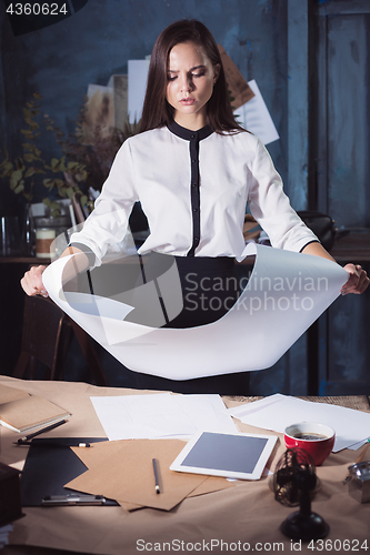 Image of Architect working on drawing table in office