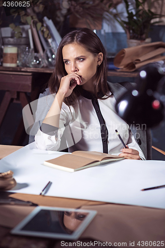 Image of Architect working on drawing table in office