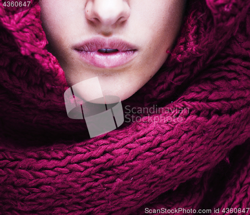 Image of young pretty woman lips in sweater and scarf all over her face