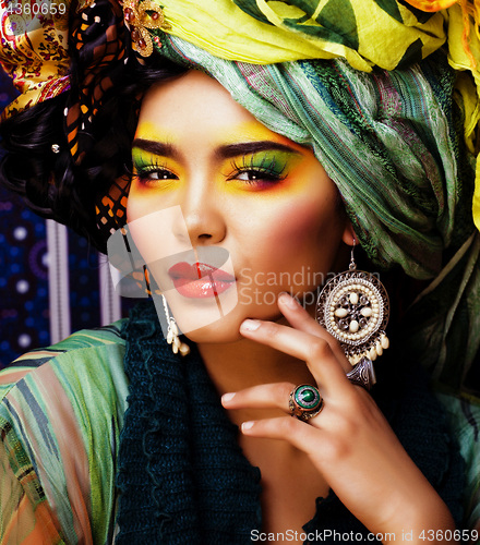 Image of beauty bright woman with creative make up, many shawls on head like cubian, ethno 