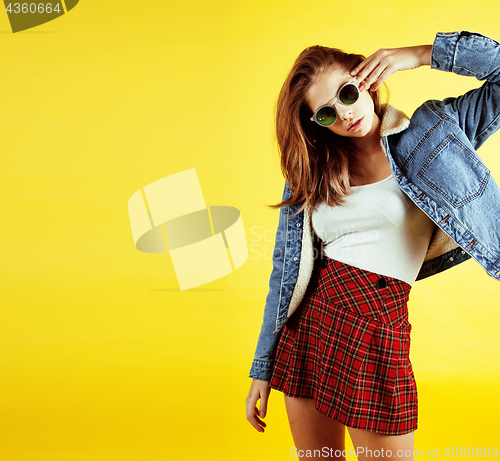 Image of lifestyle people concept: pretty young school teenage girl having fun happy smiling on yellow background 