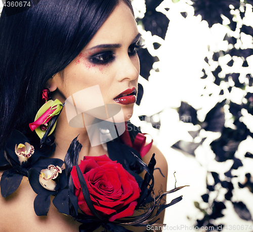 Image of pretty brunette woman with rose jewelry, black and red, bright m