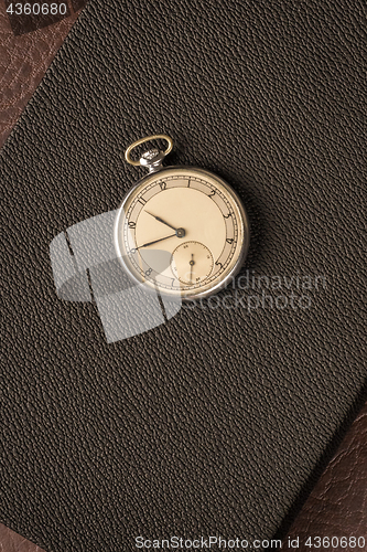 Image of Pocket watch on dark textured background
