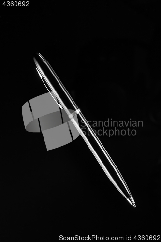 Image of Black ballpoint pen on a black background