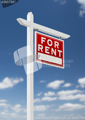 Image of Right Facing For Rent Real Estate Sign on a Blue Sky with Clouds