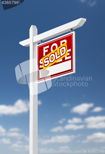 Image of Right Facing Sold For Sale Real Estate Sign on a Blue Sky with C