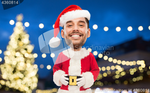 Image of man in santa claus costume over christmas lights