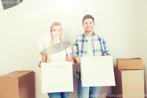 Image of smiling couple with big boxes moving to new home