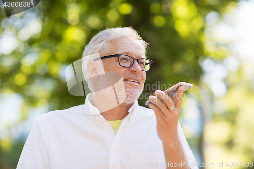 Image of old man using voice command recorder on smartphone