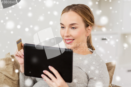 Image of happy woman with tablet pc and credit card