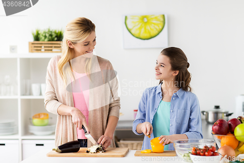 Image of happy family cooking dinner at home kitchen